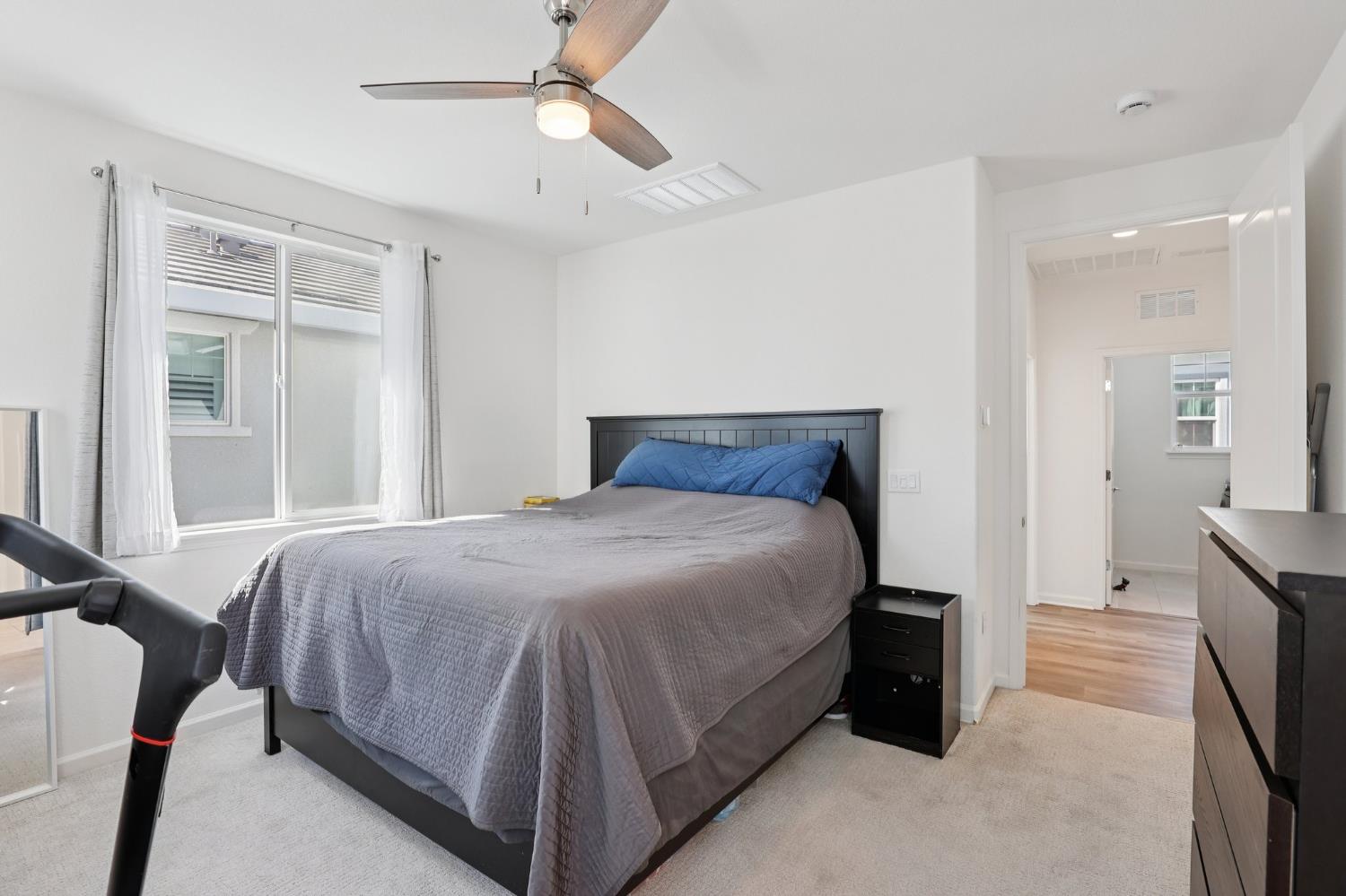 2413 Seaside Road Lathrop, CA 95330 - Photo 25 of 37 a bedroom with a bed and a chandelier