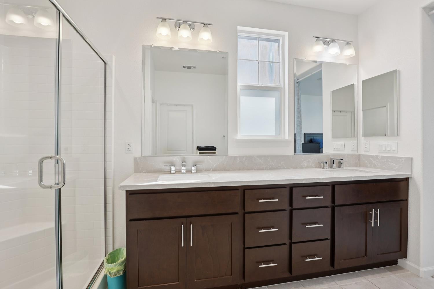 2413 Seaside Road Lathrop, CA 95330 - Photo 27 of 37 a bathroom with a sink double vanity and a mirror
