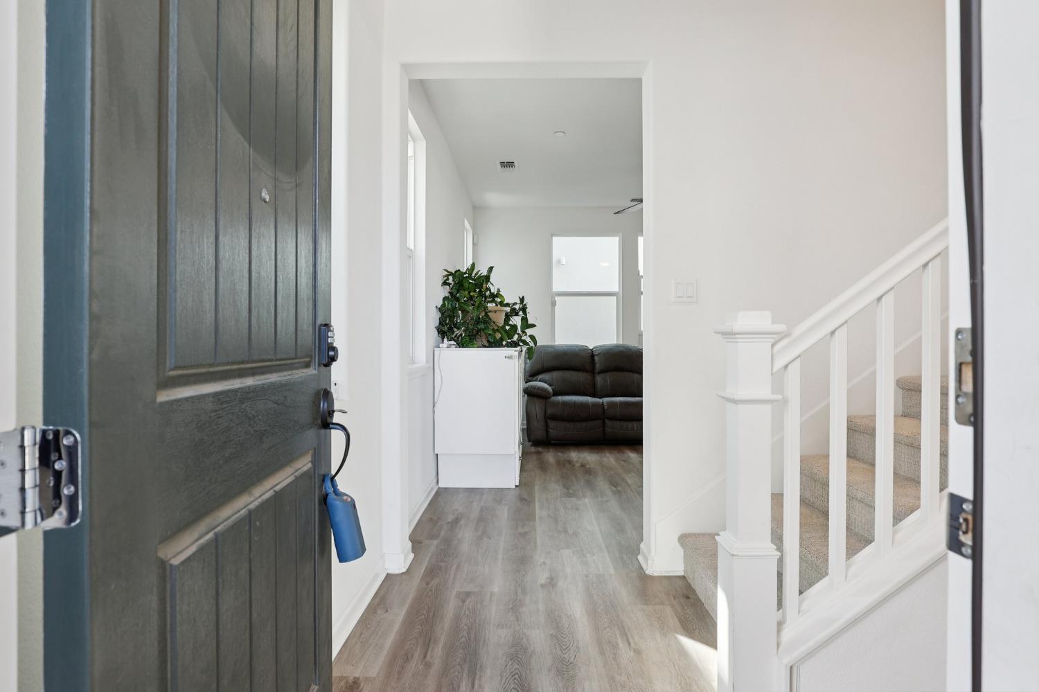 2413 Seaside Road Lathrop, CA 95330 - Photo 4 of 37 a view of entryway with livingroom and wooden floor