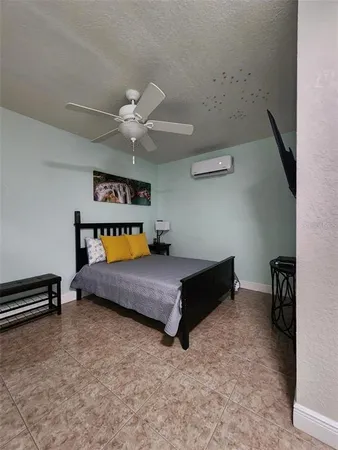 a bedroom with furniture and a ceiling fan