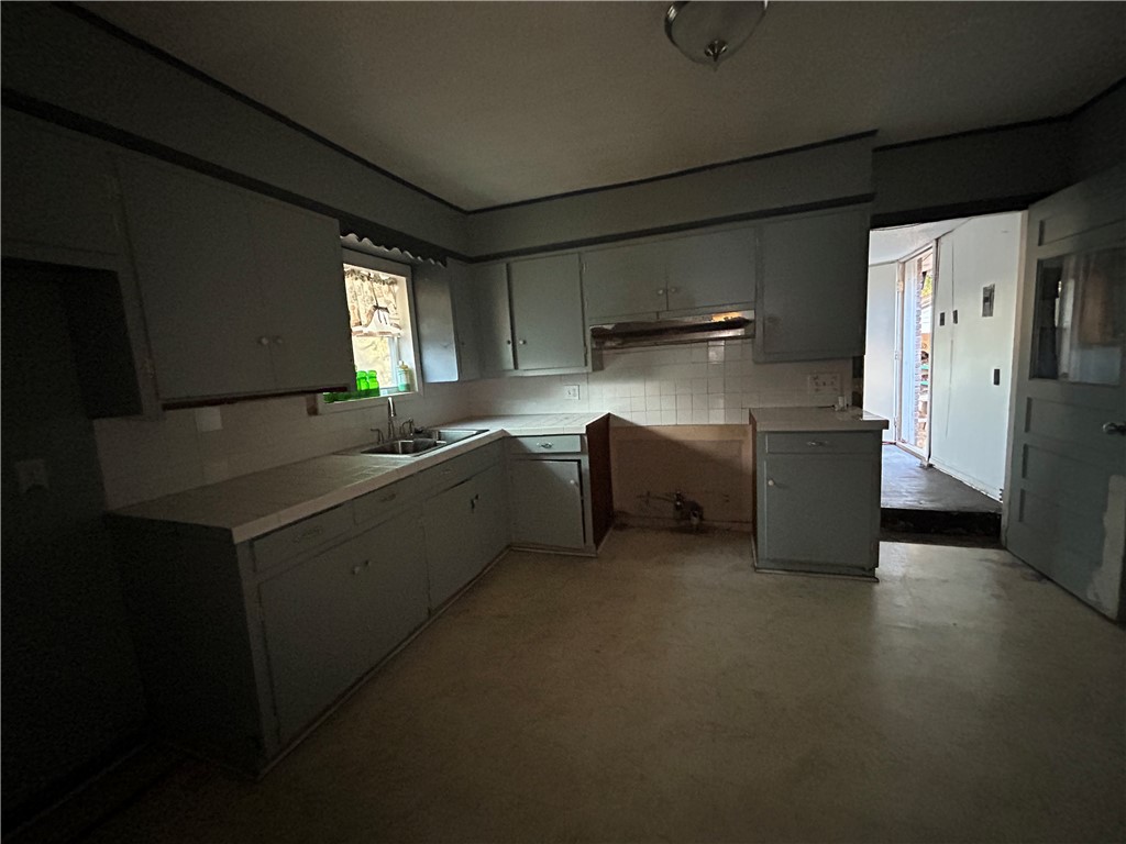 1041 East 5th Street Alice, TX 78332 - Photo 12 of 19 a kitchen with stainless steel appliances a sink stove and refrigerator