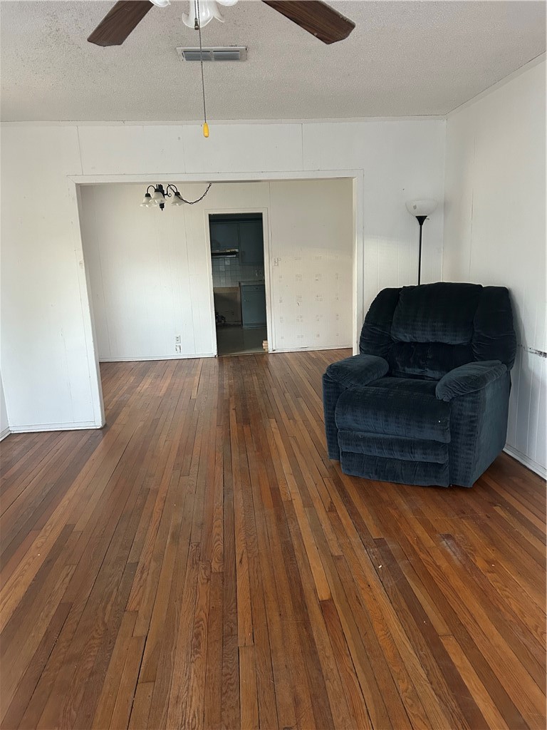 1041 East 5th Street Alice, TX 78332 - Photo 2 of 19 a living room with hard wood floors and a ceiling fan