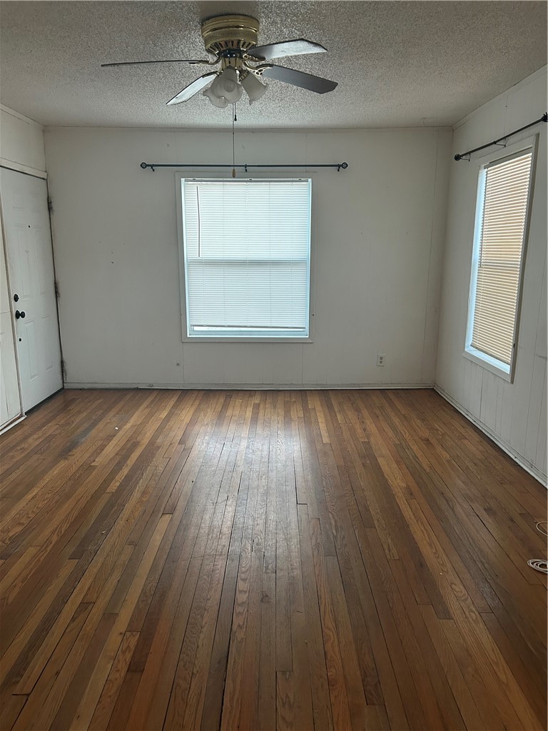 1041 East 5th Street Alice, TX 78332 - Photo 3 of 19 an empty room with wooden floor chandelier and windows