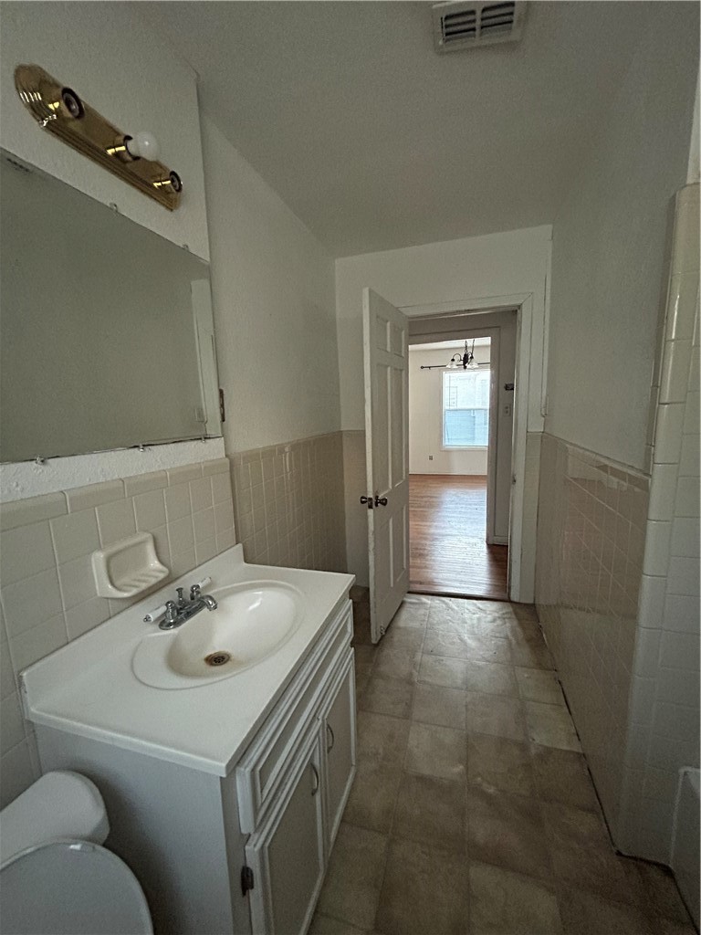 1041 East 5th Street Alice, TX 78332 - Photo 7 of 19 a bathroom with a sink toilet and shower