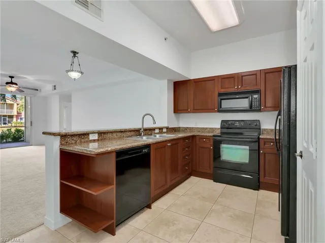 a kitchen with stainless steel appliances granite countertop a stove and a sink