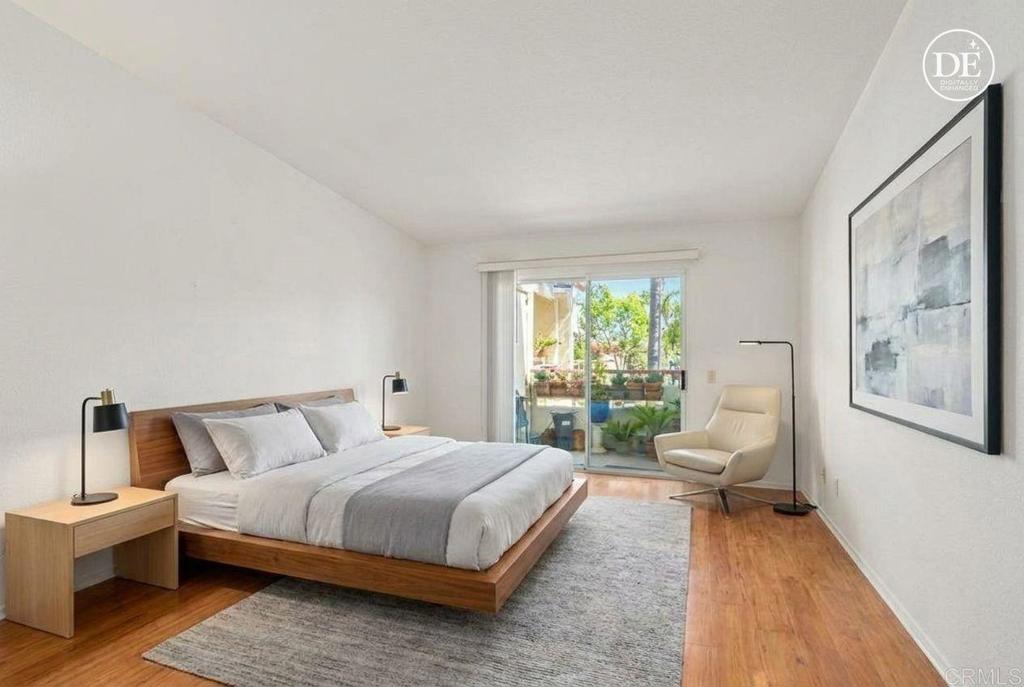 430 Stoney Point Way, Unit 129 Oceanside, CA 92058 - Photo 15 of 40 a bedroom with a bed and a large window