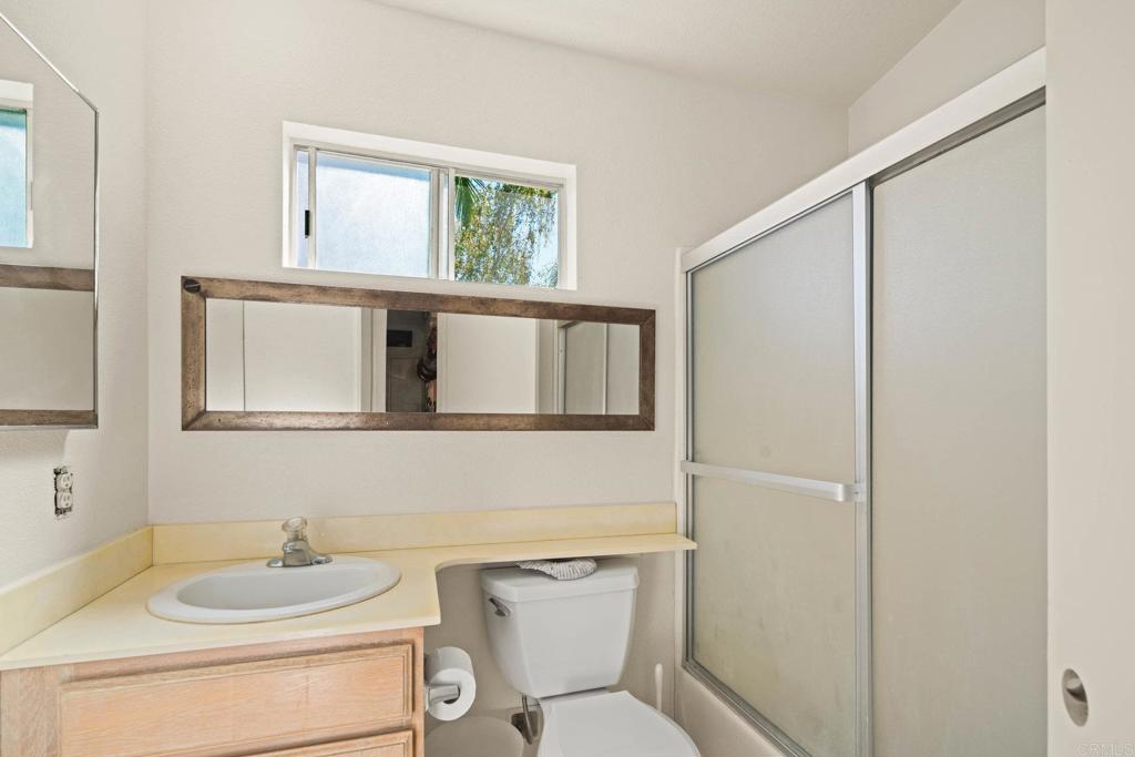 430 Stoney Point Way, Unit 129 Oceanside, CA 92058 - Photo 24 of 40 a bathroom with a toilet sink and mirror