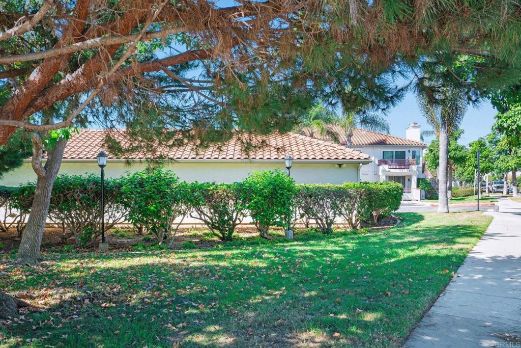 430 Stoney Point Way, Unit 129 Oceanside, CA 92058 - Photo 27 of 40 a view of a house with a yard and a fountain