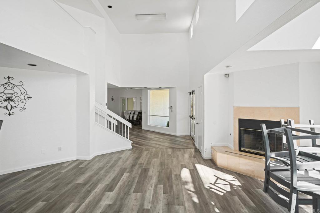 430 Stoney Point Way, Unit 129 Oceanside, CA 92058 - Photo 29 of 38 wooden floor in an empty room with a fireplace