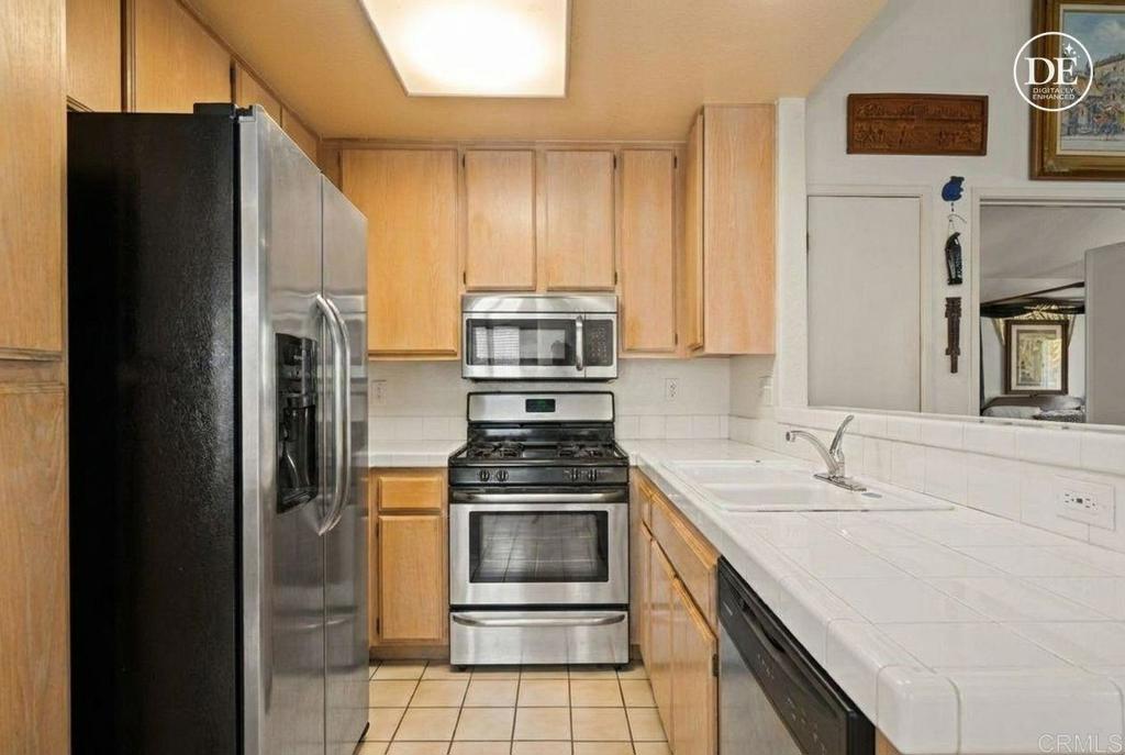 430 Stoney Point Way, Unit 129 Oceanside, CA 92058 - Photo 3 of 40 a kitchen with a sink stove and refrigerator