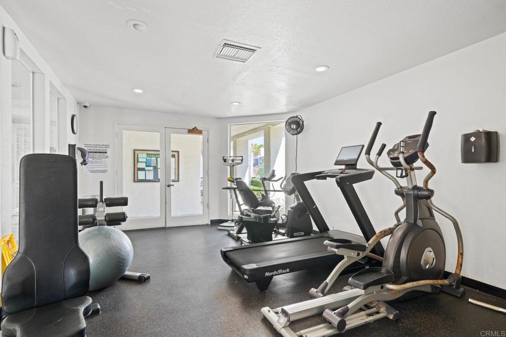430 Stoney Point Way, Unit 129 Oceanside, CA 92058 - Photo 38 of 40 a room with gym equipment and windows