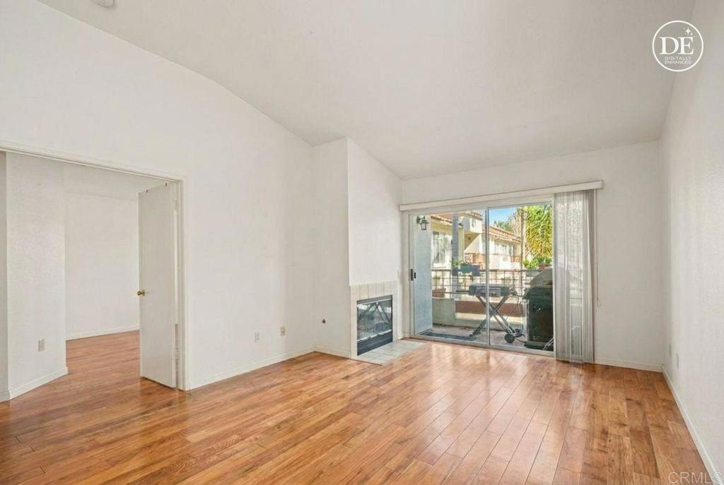 430 Stoney Point Way, Unit 129 Oceanside, CA 92058 - Photo 4 of 40 an empty room with wooden floor and windows
