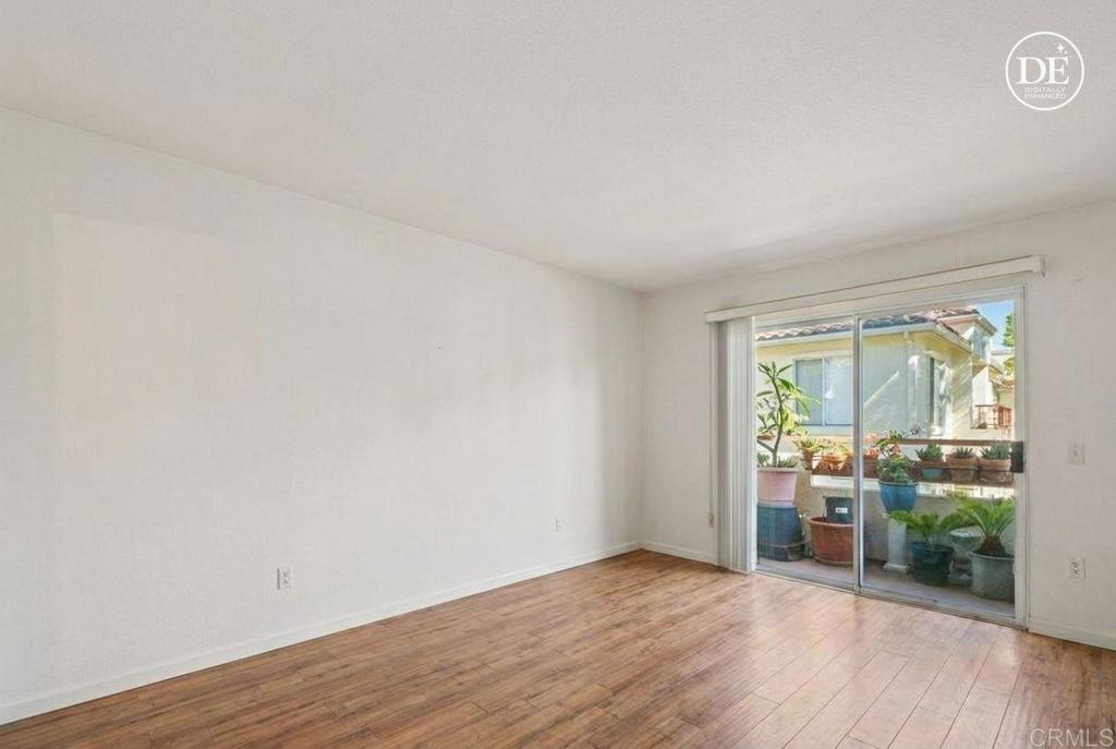 430 Stoney Point Way, Unit 129 Oceanside, CA 92058 - Photo 5 of 40 a view of a room with wooden floor and a window