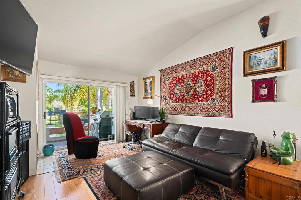 430 Stoney Point Way, Unit 129 Oceanside, CA 92058 - Photo 8 of 38 a living room with furniture and a flat screen tv