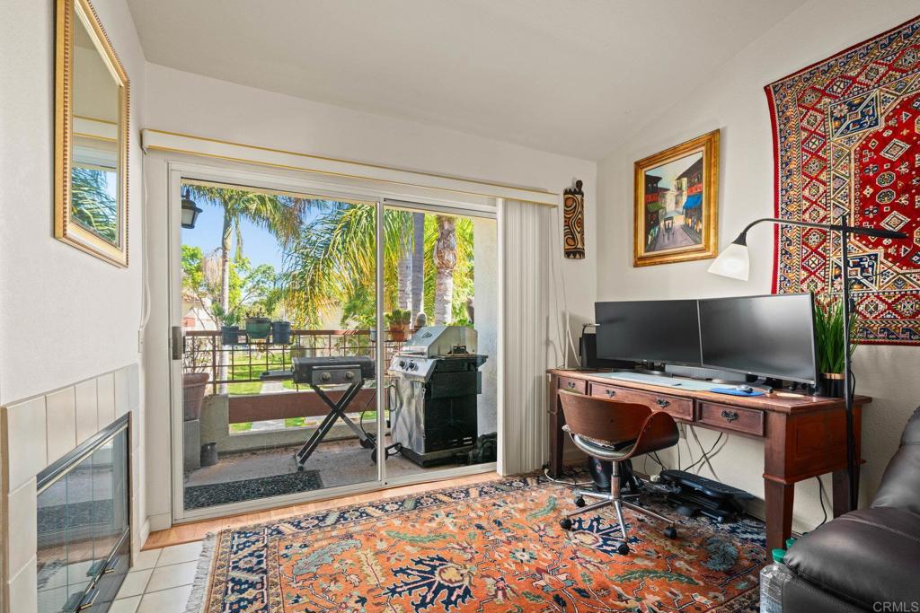 430 Stoney Point Way, Unit 129 Oceanside, CA 92058 - Photo 9 of 38 a workspace with furniture and a floor to ceiling window