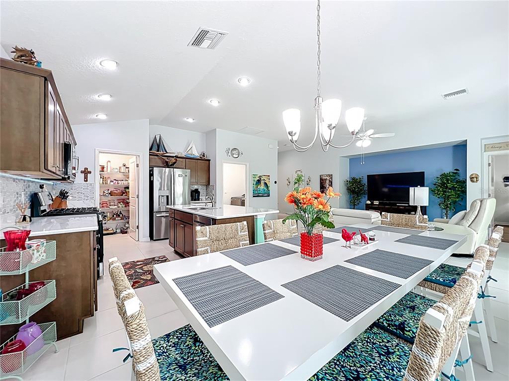 6370 Danielson Loop The Villages, FL 32163 - Photo 11 of 55 a kitchen view with microwave a stove and refrigerator