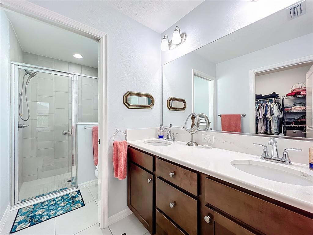 6370 Danielson Loop The Villages, FL 32163 - Photo 25 of 55 a bathroom with a granite countertop sink mirror and shower