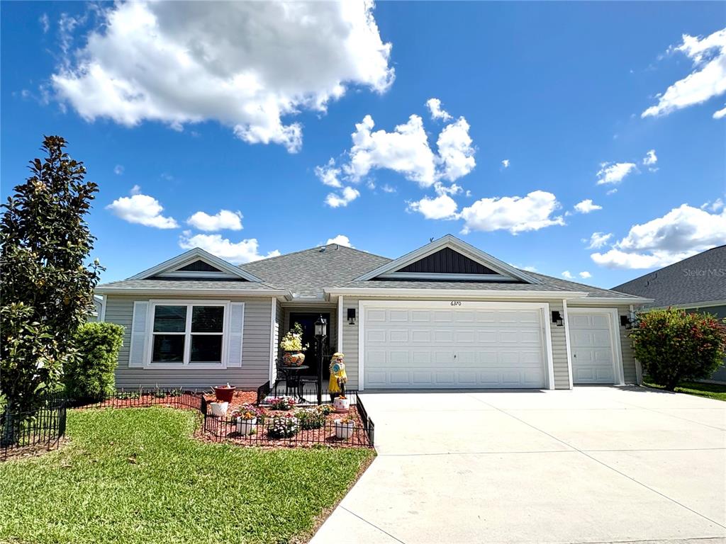 6370 Danielson Loop The Villages, FL 32163 - Photo 3 of 55 a front view of a house with garden