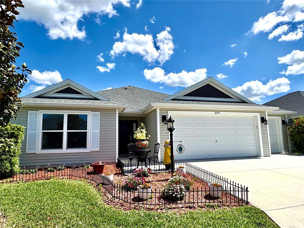 6370 Danielson Loop The Villages, FL 32163 - Photo 4 of 55 a front view of a house with garden