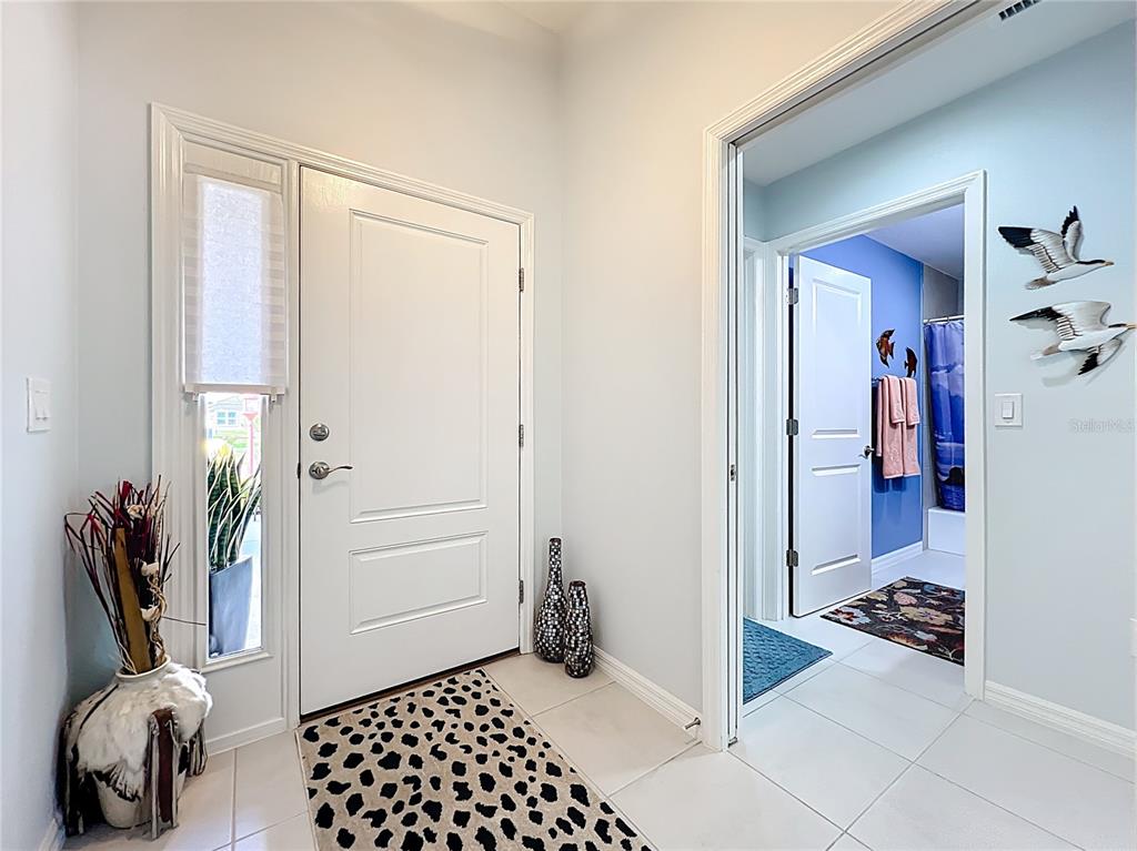 6370 Danielson Loop The Villages, FL 32163 - Photo 5 of 55 a room that has a mirror and a plant in it