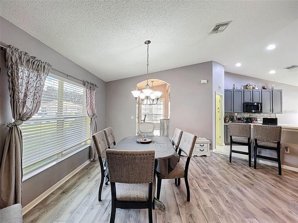 189 Center Oak Circle Spring Hill, FL 34609 - Photo 11 of 61 a dining room with furniture window and wooden floor