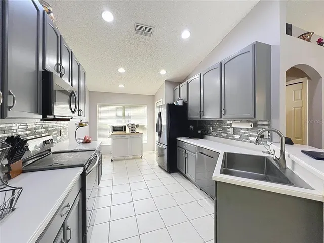 a kitchen with a sink and cabinets