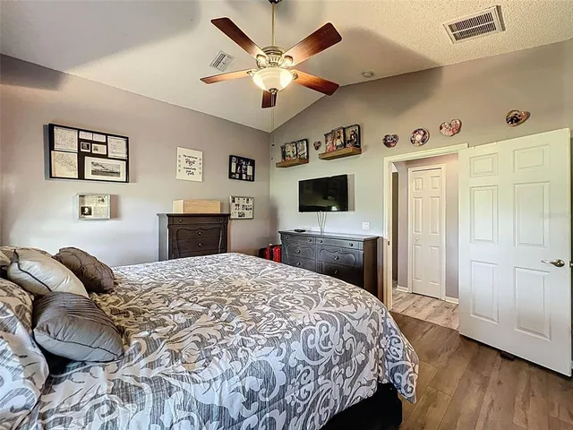 a bed room with a bed and a chandelier