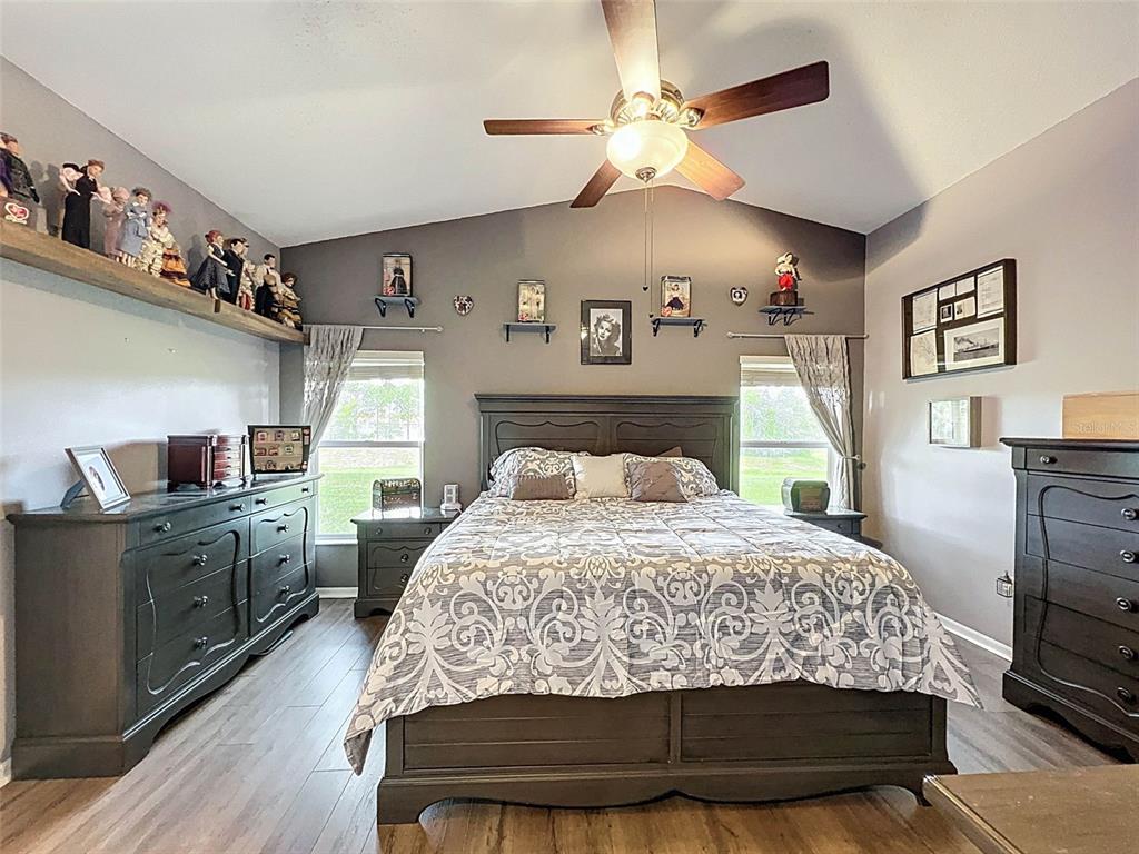 189 Center Oak Circle Spring Hill, FL 34609 - Photo 26 of 61 a bedroom with a bed and a chandelier