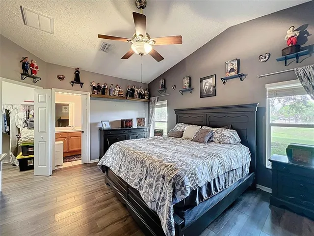 a view of an empty room with a floor to ceiling window and a ceiling fan