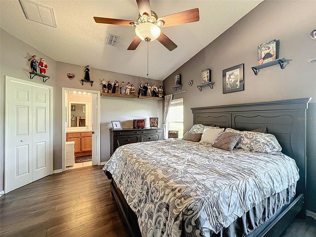 189 Center Oak Circle Spring Hill, FL 34609 - Photo 28 of 61 a bed room with a bed and a chandelier