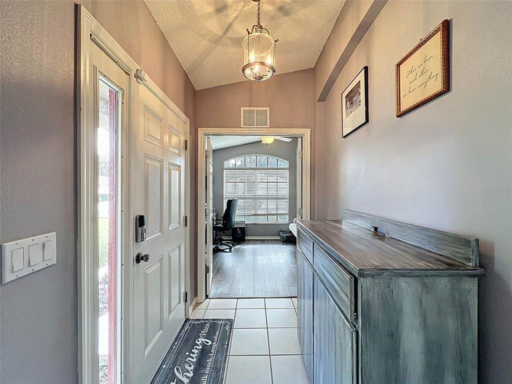 189 Center Oak Circle Spring Hill, FL 34609 - Photo 39 of 61 a bathroom with a granite countertop sink a large mirror and a shower