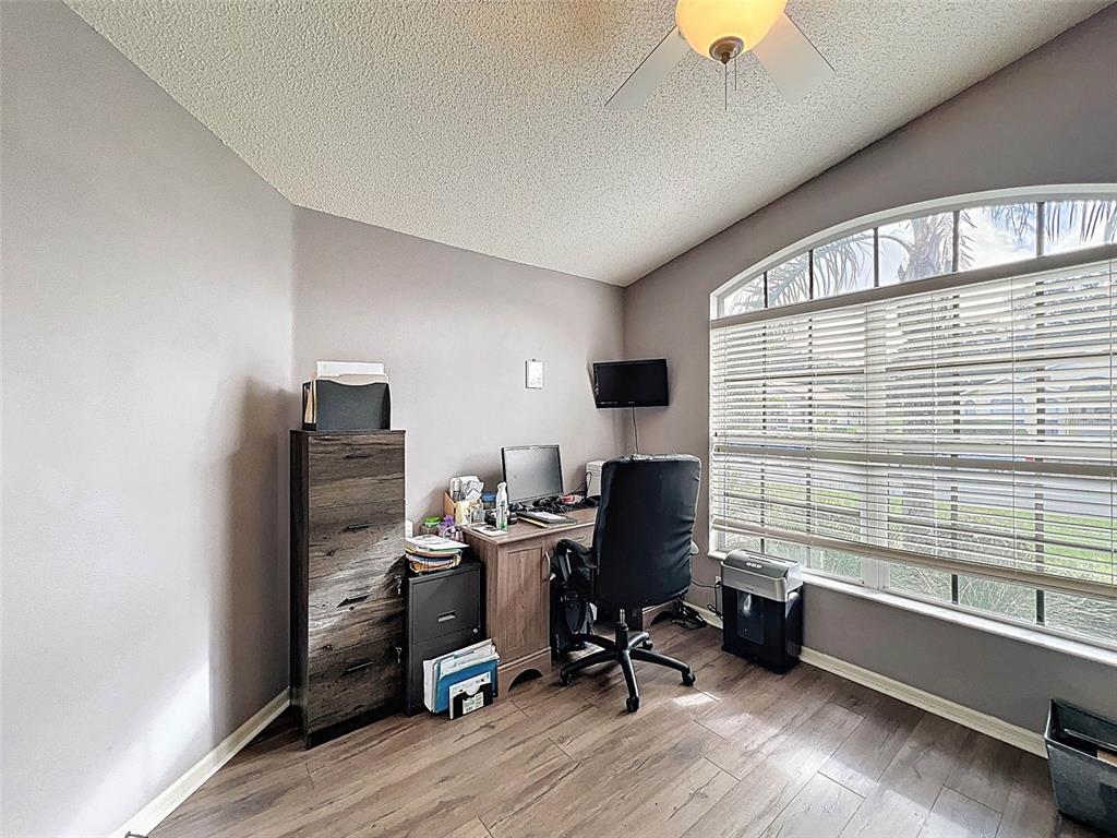 189 Center Oak Circle Spring Hill, FL 34609 - Photo 41 of 61 a view of a workspace with furniture and a window