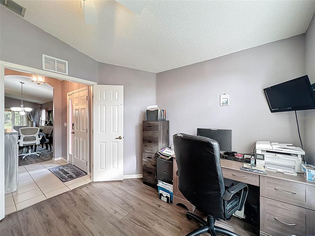 189 Center Oak Circle Spring Hill, FL 34609 - Photo 42 of 61 a view of a workspace with furniture and wooden floor