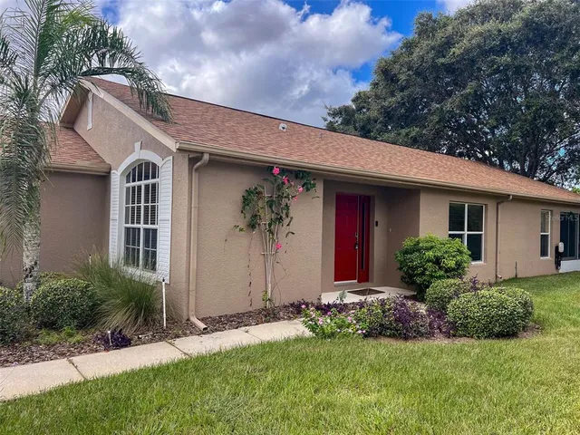 a front view of house with yard and green space