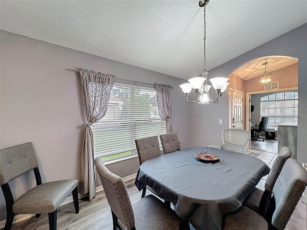 189 Center Oak Circle Spring Hill, FL 34609 - Photo 9 of 61 a view of a dining room with furniture and wooden floor