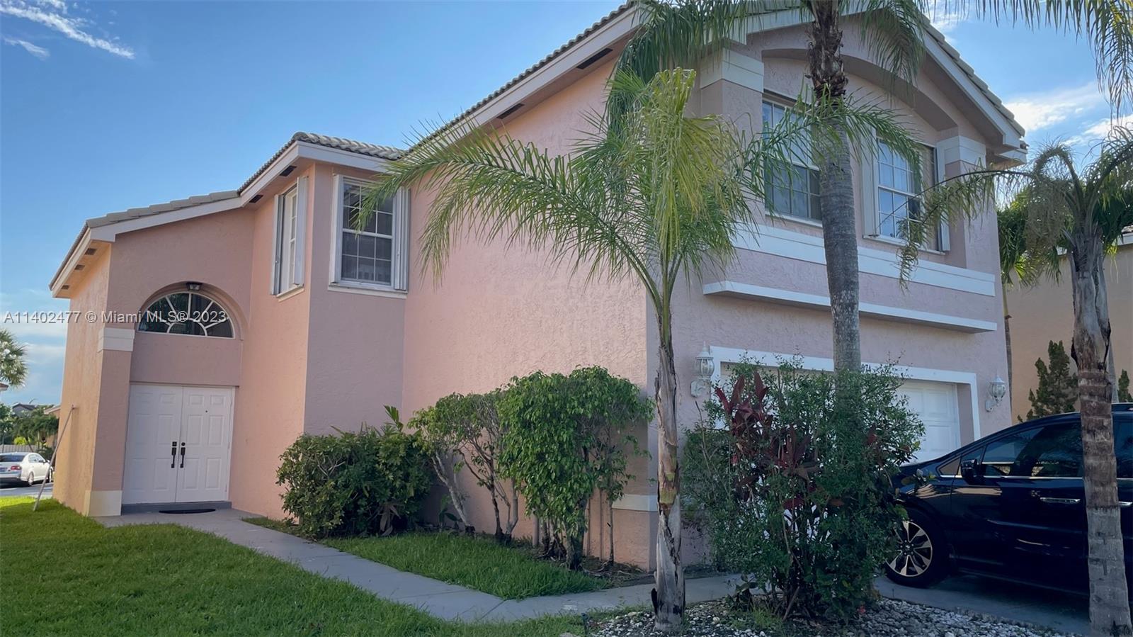 Silver Lakes Miramar, FL 33029 - Photo 2 of 14 a front view of a house with a yard
