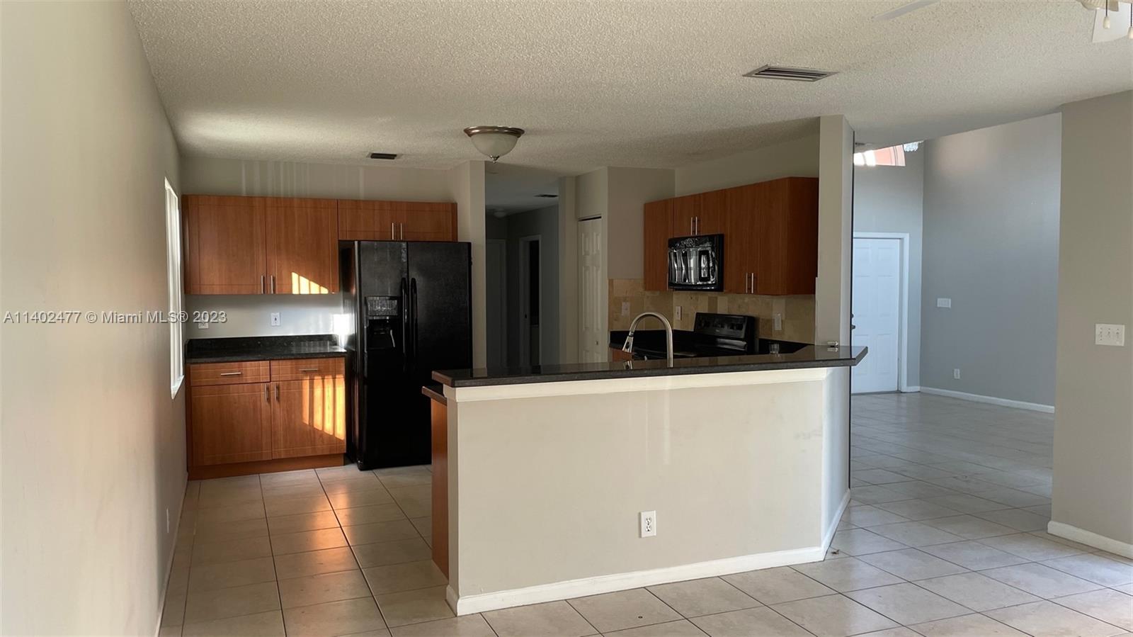 Silver Lakes Miramar, FL 33029 - Photo 6 of 14 a kitchen with stainless steel appliances a refrigerator and a stove top oven