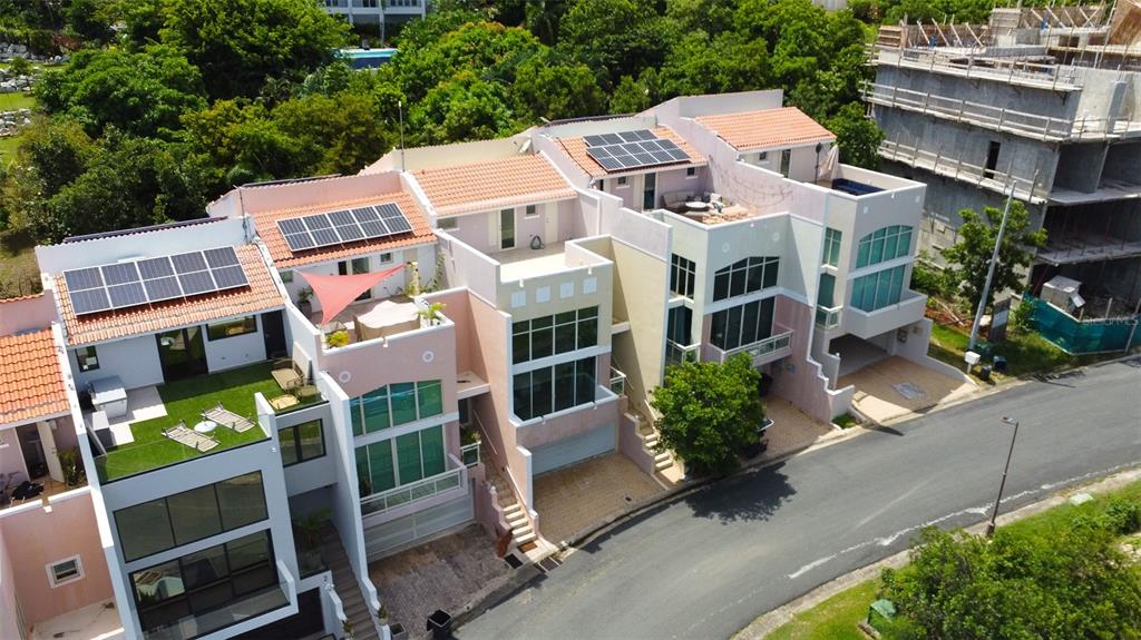 an aerial view of multiple houses with yard
