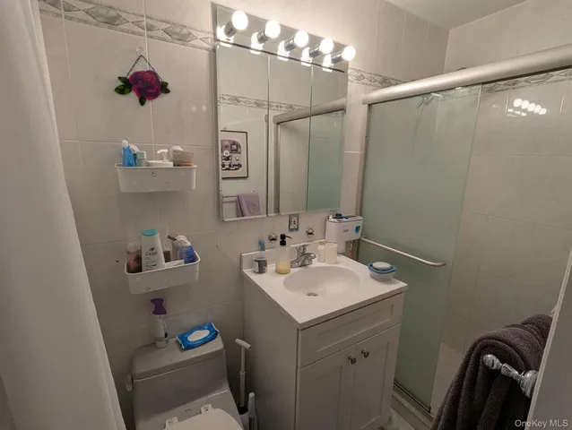 a bathroom with a sink vanity granite and toilet
