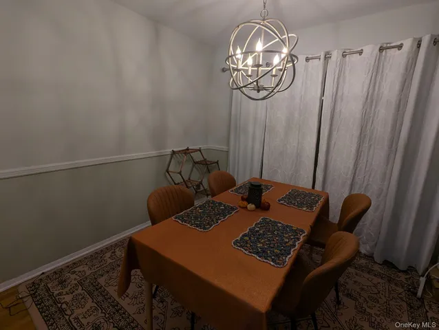 a view of a dining room with furniture and chandelier