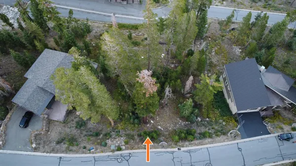 an aerial view of a house with a yard basket ball court and outdoor seating