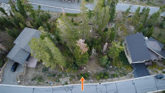 an aerial view of a house with a yard basket ball court and outdoor seating