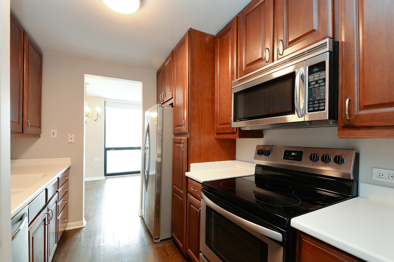 1122 North Clark Street, Unit 1203 Chicago, IL 60610 - Photo 7 of 22 a kitchen with stainless steel appliances a stove microwave and refrigerator
