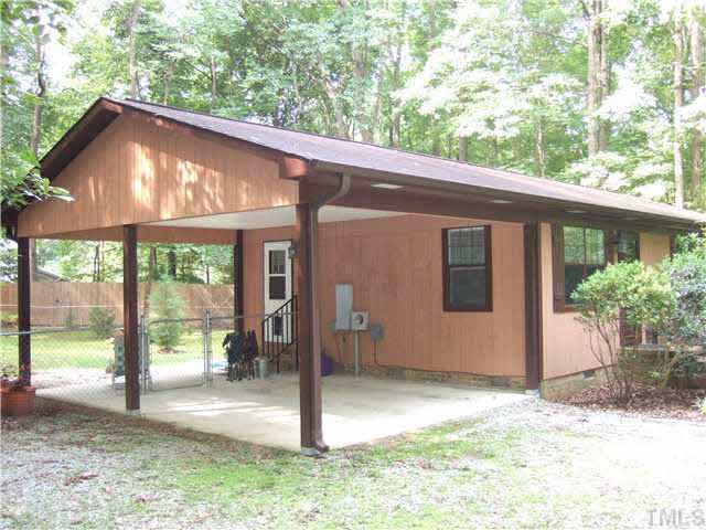 561 Willie Gray Road Timberlake, NC 27583 - Photo 1 of 23 Large carport with fence in backyard.