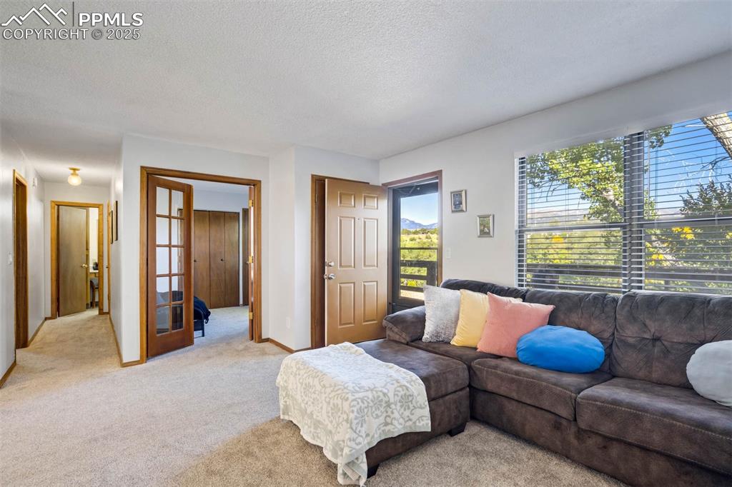 2387 Stepping Stones Way Colorado Springs, CO 80904 - Photo 13 of 35 a spacious bedroom with bed and a couch