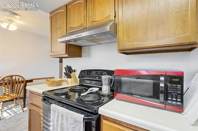 a kitchen with a stove and a microwave
