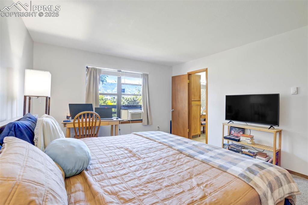 2387 Stepping Stones Way Colorado Springs, CO 80904 - Photo 19 of 35 a bedroom with bed tv and window