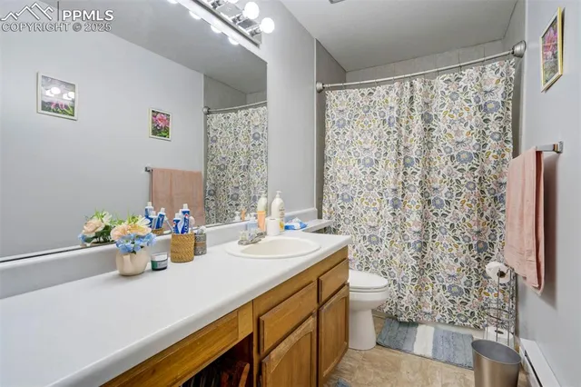 a bathroom with a sink mirror and a toilet