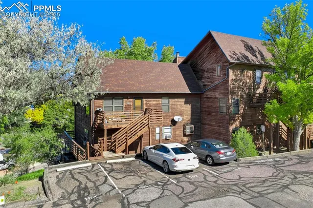 a view of a chair and tables in the back yard of the house