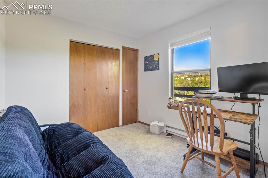 2387 Stepping Stones Way Colorado Springs, CO 80904 - Photo 22 of 35 a living room with furniture and a flat screen tv